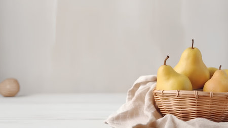 Ripe pears in a wicker basket on a light backgroundの素材