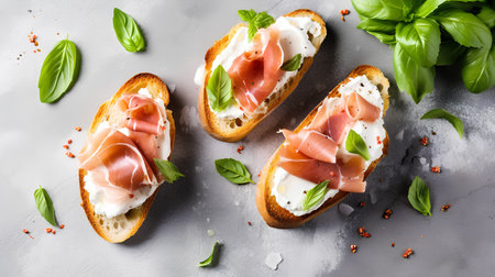 Italian bruschetta with prosciutto, mozzarella and basil on grey backgroundの素材