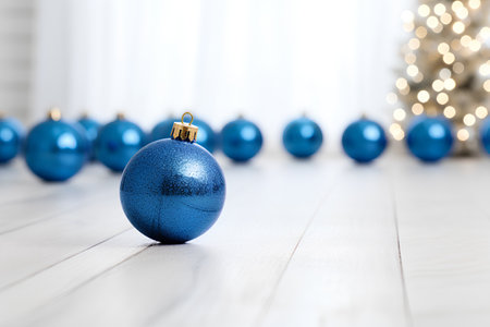 Blue Christmas ball on wooden background with christmas tree and bokehの素材