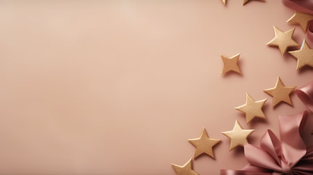 Gold stars and bow on a pink background with space for text.の素材
