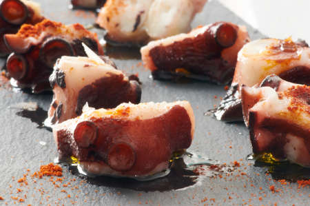 Some slices of octopus prepared at Galician style with olive oil, salt and paprikaの写真素材