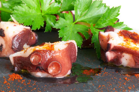 Some slices of octopus prepared at Galician style with olive oil, salt and paprikaの写真素材