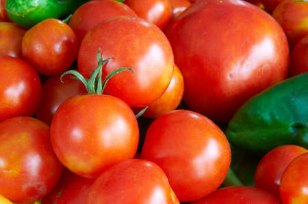 Some tomatoes and peppers in a basketの写真素材