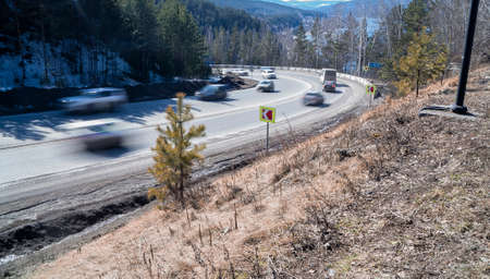Traffic flow in the daytime with a long shutter speed on the Krasnoyarsk-Divnogorsk highway. Russia.