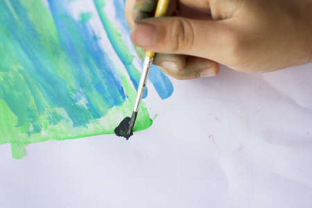 hand with brush and paintの写真素材