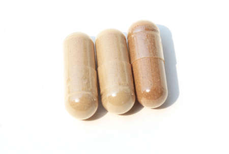 Pills. Tablets. Capsule. Heap of pills. Medical background. Close-up of pile of yellow green tablets - capsule. Pills and tablets. white background.の写真素材