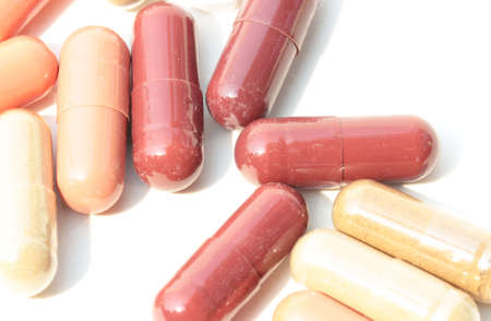 Pills. Tablets. Capsule. Heap of pills. Medical background. Close-up of pile of yellow green tablets...