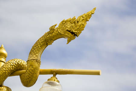 Naga statue head with blue sky backgroundの写真素材