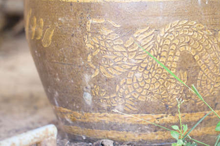 Golden dragon on the big water jarの写真素材