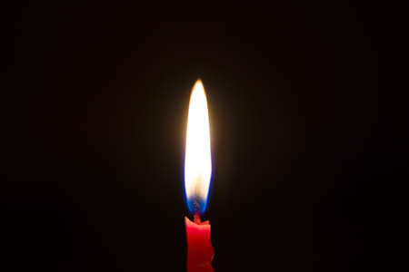 Realistic 3d red candle on a dark background with reflection. Vector illustration.の写真素材
