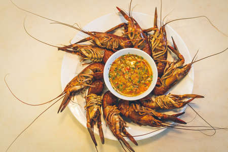 Boiled shrimp on table with seafood sauce,thai style food,vintage styleの写真素材