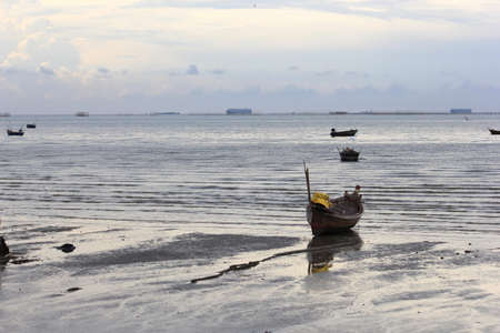 Wooden fishing boat on a sandy beachの写真素材