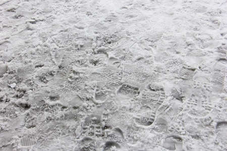 Many shoeprints in the dirty snowの写真素材