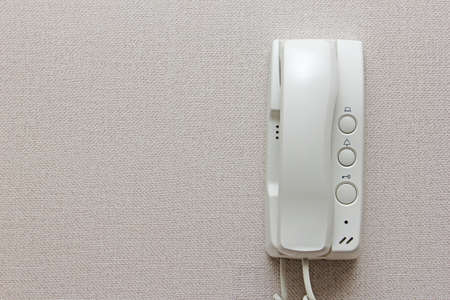 white Intercom phone hung on a wallの写真素材