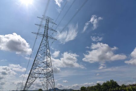 High voltage tower, Electric post and electric cable on the field in the countryside with white...