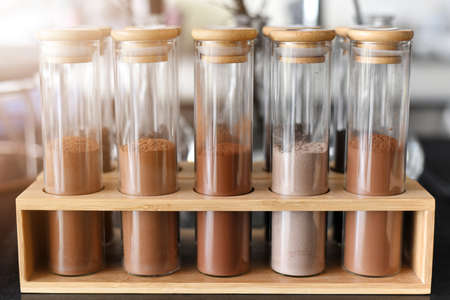 crude dark cocoa powder in a glass tube Many levels or raw chocolate powder ingredients for preparing chocolate or sweets.の写真素材