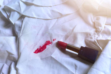 Stains of lipstick or makeup on white clothes or stains on clothes from everyday accidents. Concept of cleaning stains on clothes or cleaning the house. Selected focusの写真素材
