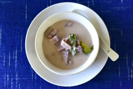 Top view of Sweet potatoes in light ginger syrup or Thai Dessert is Mun Tom King with Pandan Leaves in a white bowl. Close upの写真素材