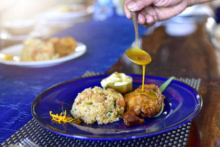 African national dish grilled chicken With fried rice and flavored water. Healthy lifestyle eating. on a white plate. selective focusの写真素材