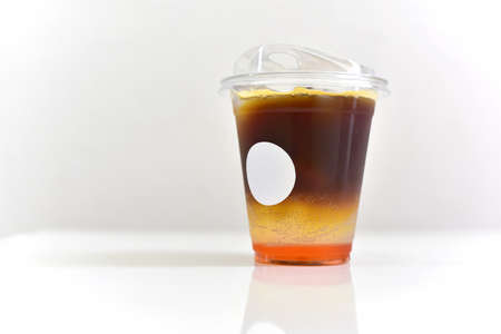 Iced Espresso Tonic. Close up of espresso shot serve with tonic water or Richie Soda on a white table and copy space.の写真素材
