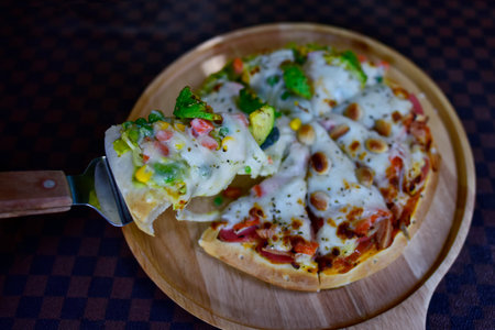 Slice of hot Homemade Pizza Topping Avocado and Macadamia With vegetables, tasty, traditional...
