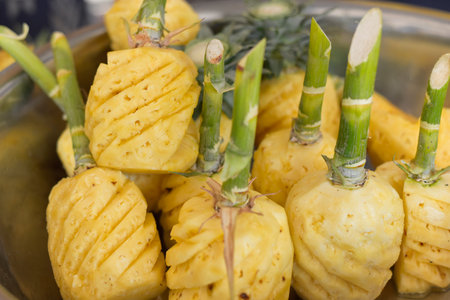 Sliced delicious ripe pineapple yellow, pieces of sweet and juicy pineapple cut on a cutting board.の写真素材