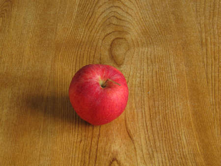 A red apple left on a tableの写真素材