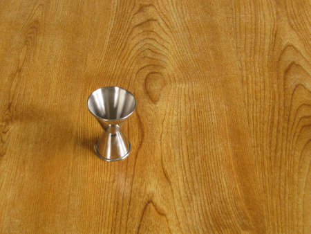 An aluminium drinks measure left on a tableの写真素材