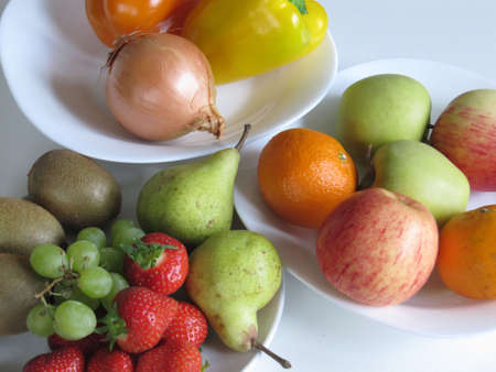 Fruit and vegetables displayed on a white backgroundの写真素材