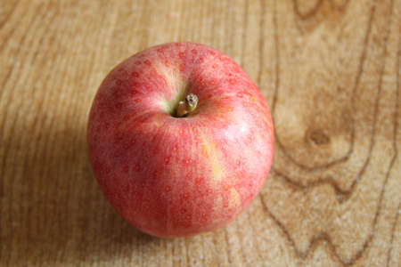 A single red apple on a tableの写真素材