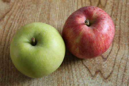A red apple and a green apple side by sideの写真素材