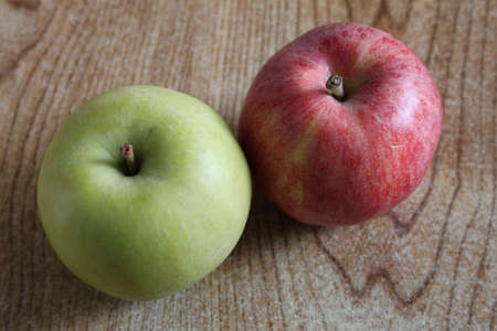 A red apple and a green apple side by sideの写真素材