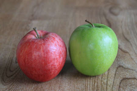 A red apple and a green apple side by sideの写真素材