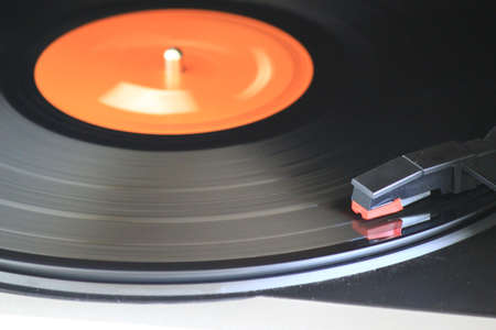 A vinyl record being played on a dusty old turntable