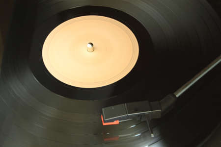 A vinyl record being played on a dusty old turntableの写真素材