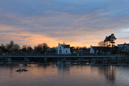 The sun setting on the River Corrib in Galway, Ireland.の写真素材
