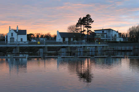 The sun setting on the River Corrib in Galway, Ireland.の写真素材