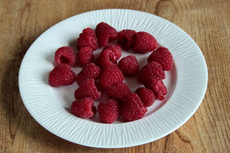 a plate of strawberries displayed on a table topの写真素材