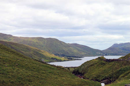 A photograph showing a view of a lake and mountainsの写真素材