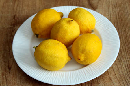 a plate of lemons displayed on a table topの写真素材