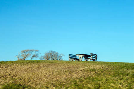 A lone Picnic Bench on a hillの写真素材