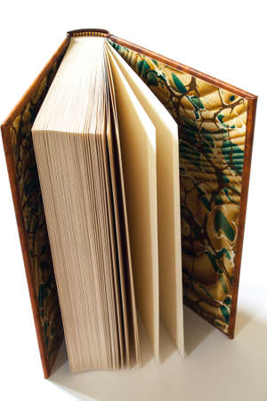 A slightly open book displayed on a white backgroundの写真素材