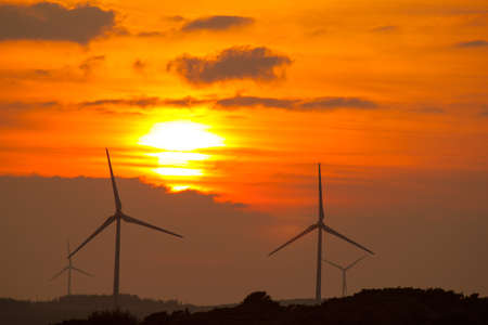 Sunset with wind turbines at Barna Co. Galway Ireland.の写真素材