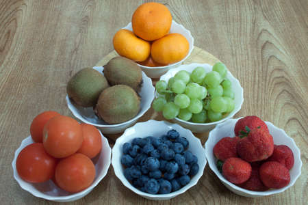 Six bowls of fruitの写真素材