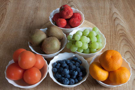 Six bowls of fruitの写真素材
