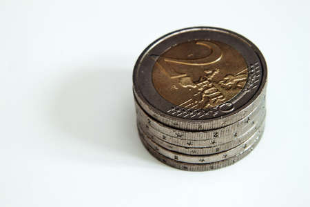 A stack of 2 Euro coins on a white backgroundの写真素材