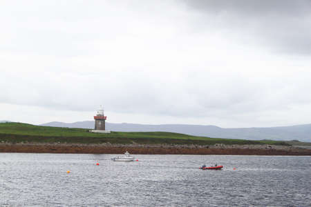 Waterscape with boats and a towerの写真素材