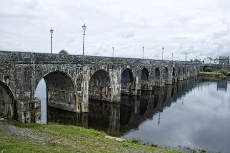 A plain looking stone bridge with a lot of arches.の写真素材