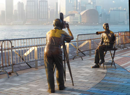Victoria Harbour, Hong Kong - February 2, 2014: An early morning glimpse of a traditional film director and cameraman statues, displayed in front of the harbour at the Avenue of Stars. The Avenue of Stars ocated along the Victoria Harbour waterfront in Tsのeditorial素材