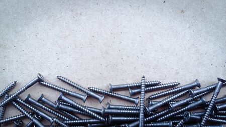 A pile of screws with blank for text.の写真素材